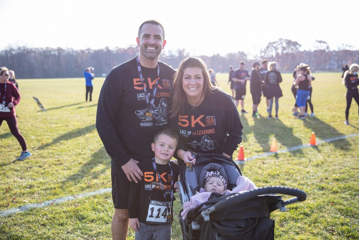 Dr. Nicole Wax smiles and poses with her husband and children.